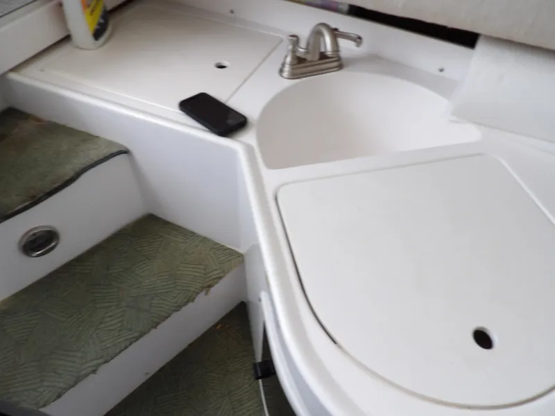 Slide: The Image of 1997 Hydra-Sports 2750 WA boat interior with sink and steps. - 31
