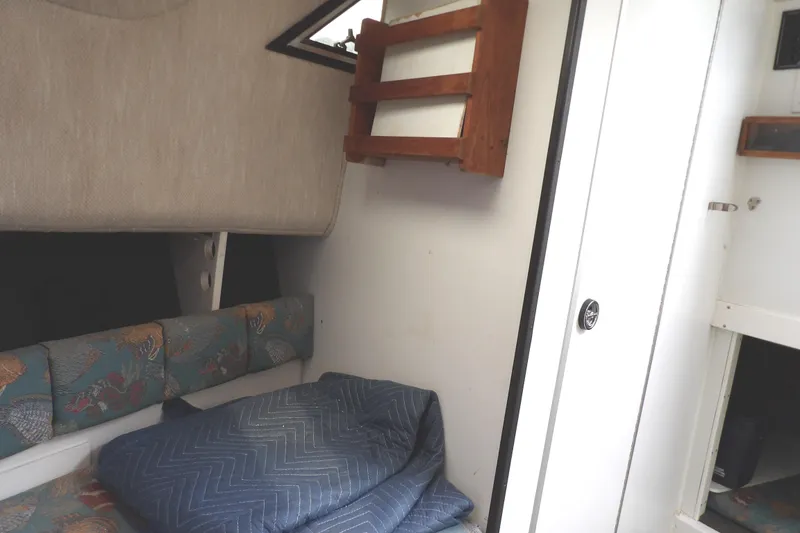 Slide: The Image of 1997 Hydra-Sports 2750 WA cabin interior with cushions and wooden shelving. - 32