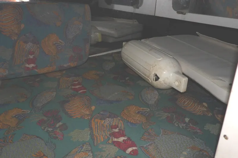 Slide: The Image of 1997 Hydra-Sports 2750 WA cabin interior with colorful fish-patterned upholstery and a white fender. - 36
