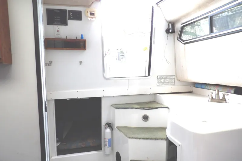 Slide: The Image of Interior of 1997 Hydra-Sports 2750 WA boat, featuring steps and a small sink area. - 37