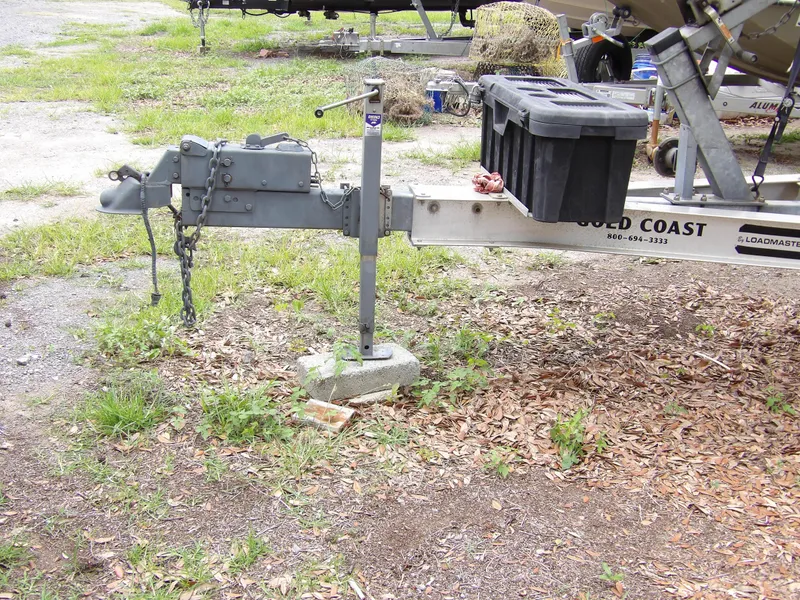 Slide: The Image of Trailer hitch of a 1997 Hydra-Sports 2750 WA boat, parked on grassy ground. - 39