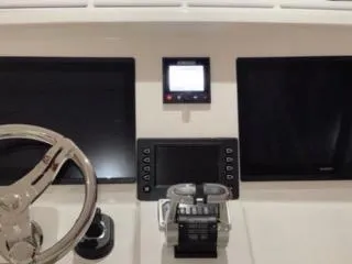 Slide: The Image of 2017 Intrepid 475 Sport Yacht helm with dual screens and steering wheel. - 5