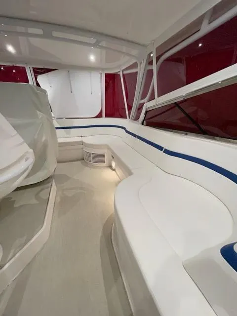 Slide: The Image of Interior of a 2017 Intrepid 475 Sport Yacht with white seating and red accents. - 6