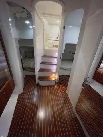 Slide: The Image of 2017 Intrepid 475 Sport Yacht interior with wooden flooring and stairs - 7