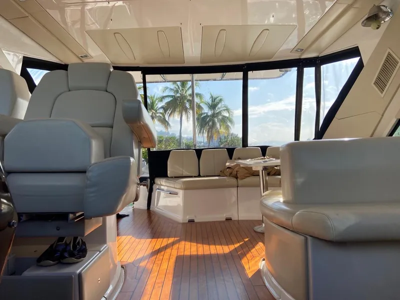 Slide: The Image of Interior of 2015 Regal 42 Sport Coupe yacht with leather seating and panoramic windows. - 14