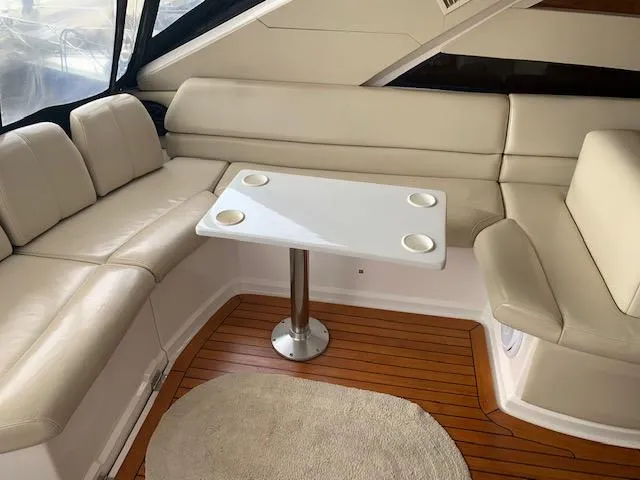 Slide: The Image of Luxurious interior seating of 2015 Regal 42 Sport Coupe yacht with white leather and wooden flooring. - 15