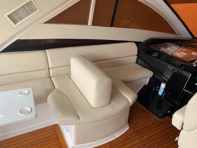 Slide: The Image of Interior seating area of 2015 Regal 42 Sport Coupe yacht with beige leather upholstery. - 16