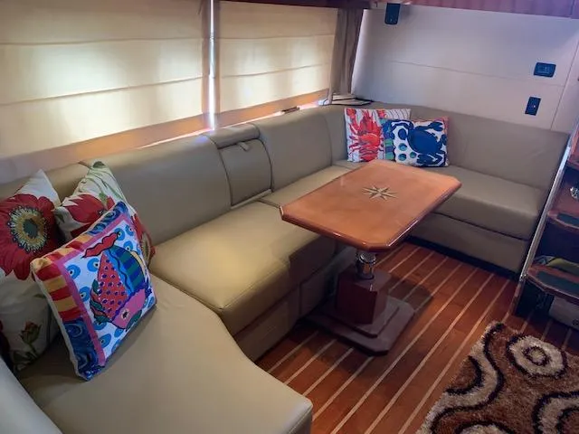 Slide: The Image of Luxurious interior of 2015 Regal 42 Sport Coupe with beige leather seating and colorful pillows. - 18