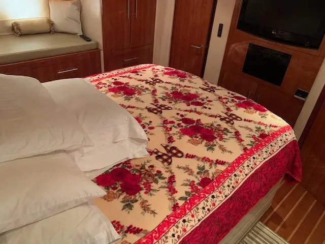 Slide: The Image of Luxurious bedroom interior of 2015 Regal 42 Sport Coupe with floral bedspread. - 23