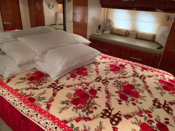 Slide: The Image of Luxurious bedroom in a 2015 Regal 42 Sport Coupe yacht with floral bedding. - 24