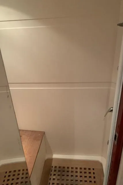 Slide: The Image of 2015 Regal 42 Sport Coupe interior shower with wooden bench and flooring. - 26