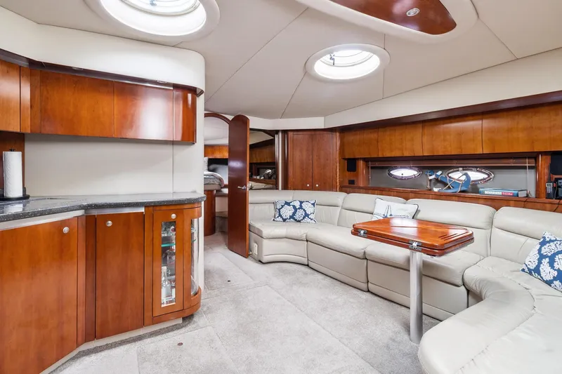 Slide: The Image of Luxurious interior of 2007 Cruisers Yachts 520 Express with leather seating and wooden cabinetry. - 11
