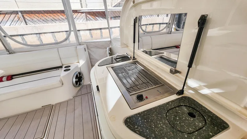 Slide: The Image of 2007 Cruisers Yachts 520 Express cockpit with grill and seating area. - 28