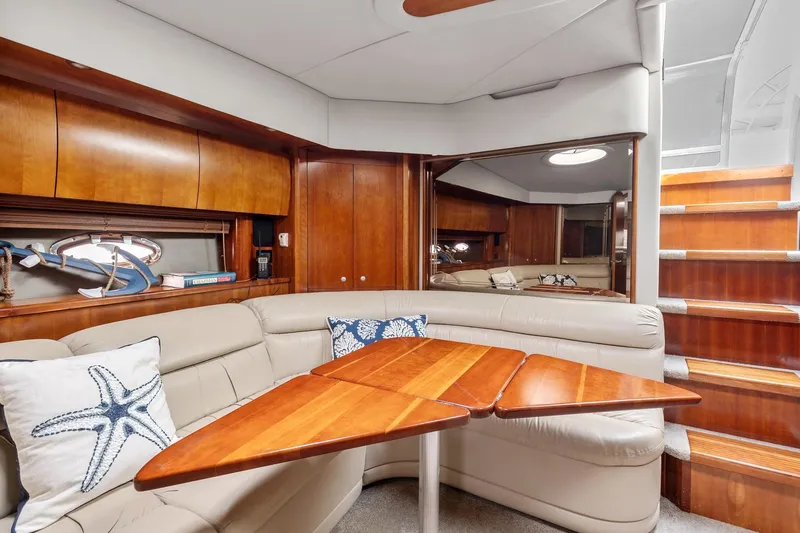 Slide: The Image of Luxurious interior of 2007 Cruisers Yachts 520 Express with wooden table and leather seating. - 8
