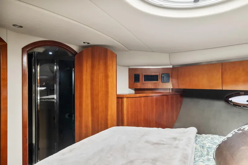 Slide: The Image of Interior cabin of 2007 Cruisers Yachts 520 Express with wooden cabinetry and cozy bed. - 13