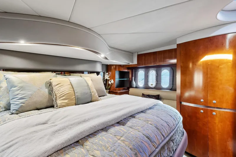 Slide: The Image of Luxurious bedroom interior of 2007 Cruisers Yachts 520 Express with plush bedding and wooden cabinetry. - 16