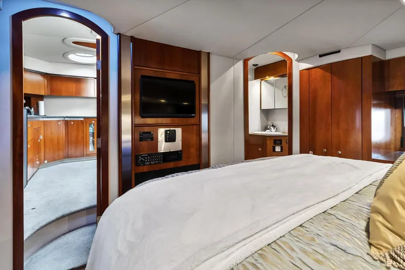 Slide: The Image of Luxurious bedroom interior of 2007 Cruisers Yachts 520 Express with TV and wooden cabinetry. - 19