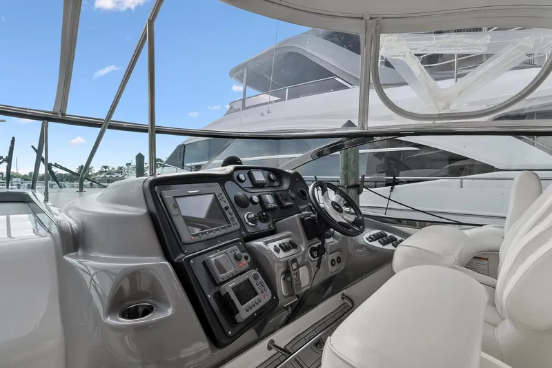Slide: The Image of 2007 Cruisers Yachts 520 Express helm with navigation controls and white seating. - 39