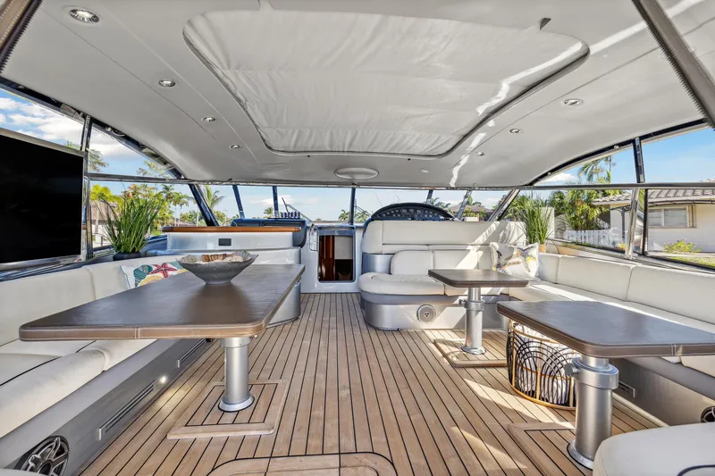 Slide: The Image of Luxurious 2003 Baia Panther yacht interior with spacious seating and elegant wooden flooring. - 17