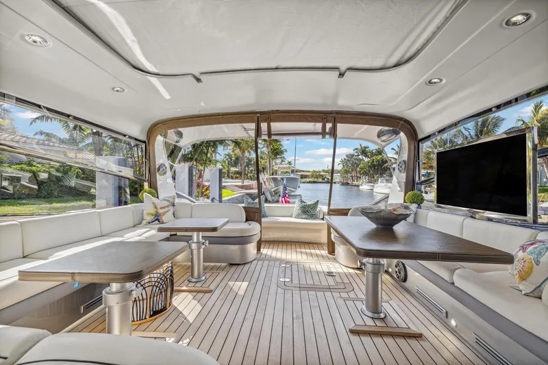 Slide: The Image of Luxurious interior of a 2003 Baia Panther yacht with modern furnishings and scenic water view. - 21