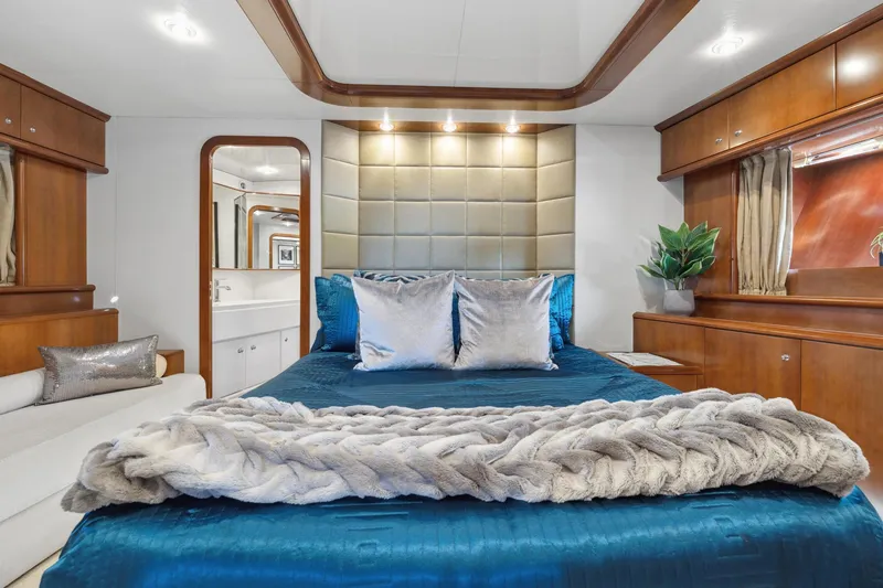 Slide: The Image of Luxurious bedroom interior of 2003 Baia Panther yacht with plush bedding and elegant wood finishes. - 38