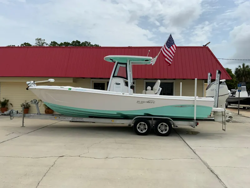 The Image of 2021 Blue Wave 2800 Makaira boat on trailer with American flag. - 0