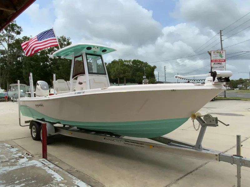 Slide: The Image of 2021 Blue Wave 2800 Makaira boat on trailer with American flag. - 1