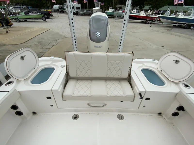 Slide: The Image of 2021 Blue Wave 2800 Makaira boat with cushioned seating and storage compartments. - 7
