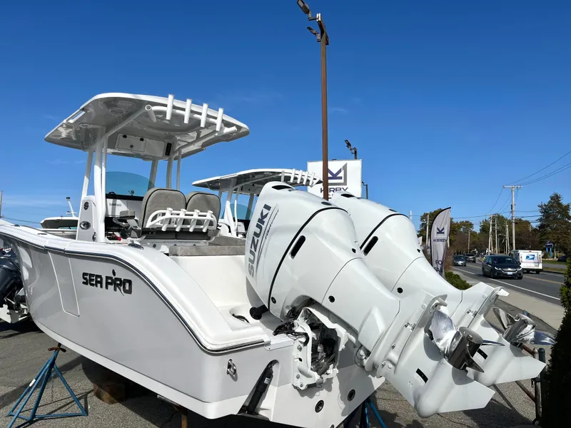 The Image of 2024 Sea Pro 262CC boat with dual engines displayed outdoors. - 0