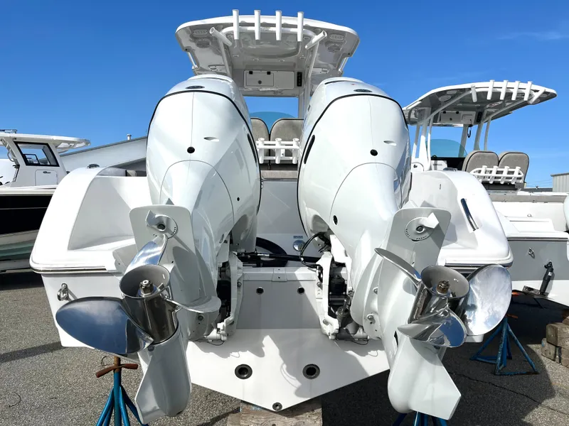Slide: The Image of 2024 Sea Pro 262CC boat with dual outboard engines, rear view. - 6