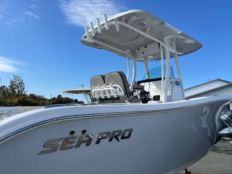 Slide: The Image of 2024 Sea Pro 262CC boat with T-top and seating, side view. - 7