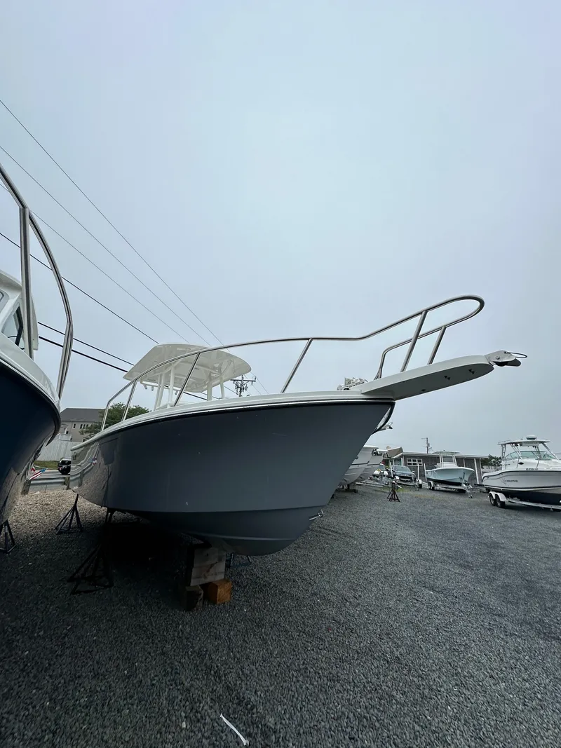 Slide: The Image of 2023 Parker 2500 Special Edition boat on gravel lot, side view. - 7