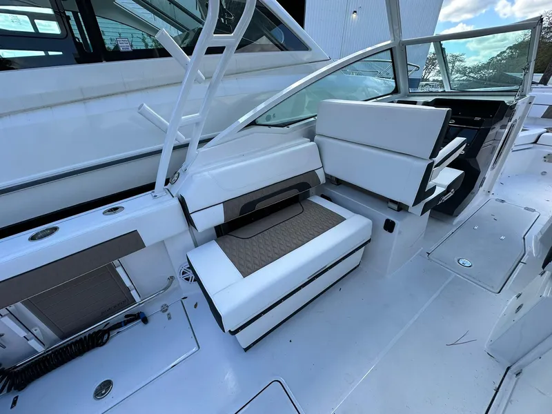 Slide: The Image of 2024 Blackfin 272 DC boat interior with white and brown seating. - 10