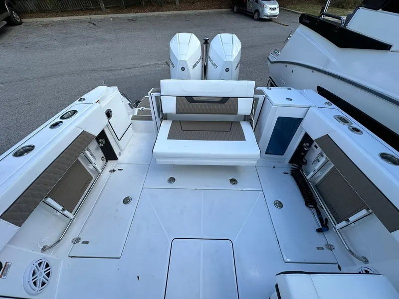 Slide: The Image of 2024 Blackfin 272 DC boat deck with seating and twin engines. - 11