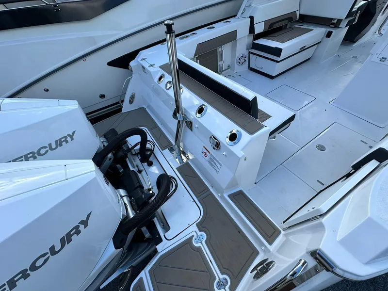 Slide: The Image of 2024 Blackfin 272 DC boat interior with Mercury engines and seating area. - 14