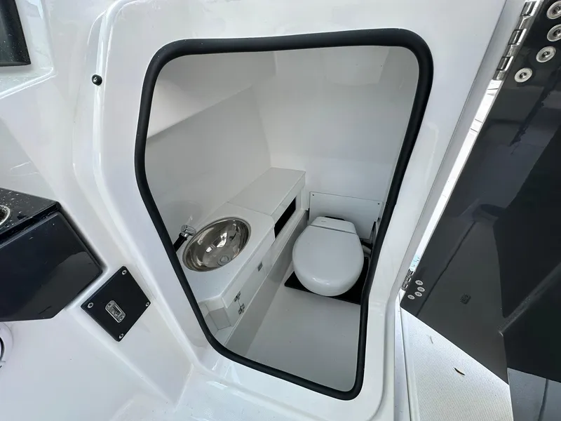 Slide: The Image of 2024 Blackfin 272 DC boat interior bathroom with sink and toilet. - 6