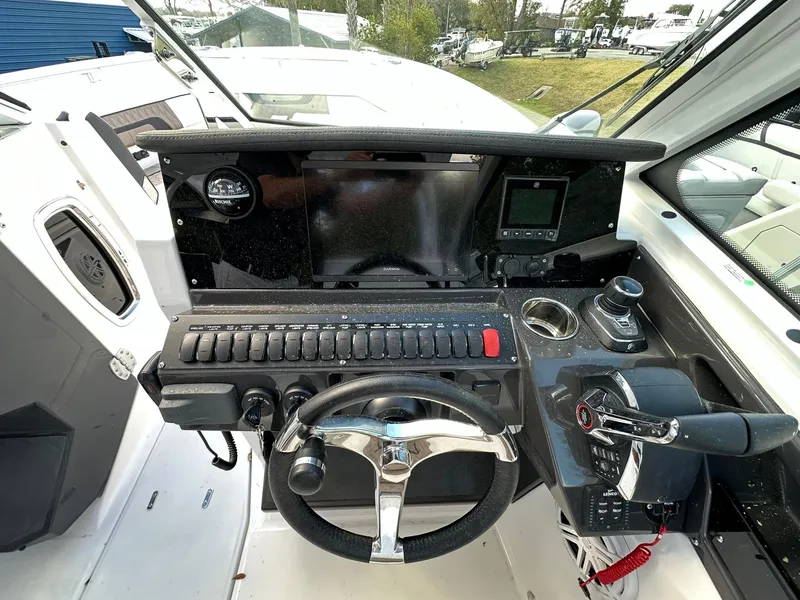 Slide: The Image of 2024 Blackfin 272 DC boat dashboard with steering wheel and control panel. - 8