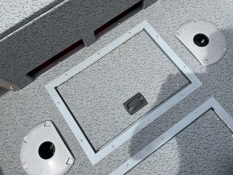 Slide: The Image of 2023 Starcraft Stealth 166 DC boat interior with storage compartment and seat bases. - 15