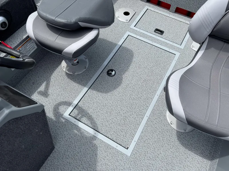 Slide: The Image of 2023 Starcraft Stealth 166 DC boat interior with gray seating and storage compartments. - 17