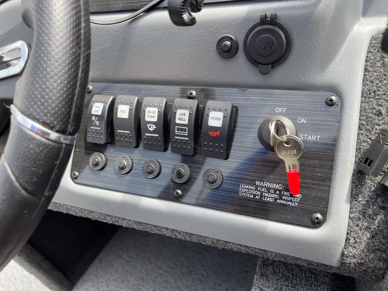 Slide: The Image of Control panel of a 2023 Starcraft Stealth 166 DC boat with ignition key. - 19