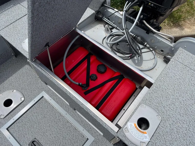 Slide: The Image of Starcraft Stealth 166 DC 2023 boat fuel tank compartment with red fuel tank and wiring. - 4