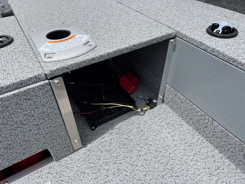 Slide: The Image of 2023 Starcraft Stealth 166 DC boat storage compartment with wiring and battery. - 8