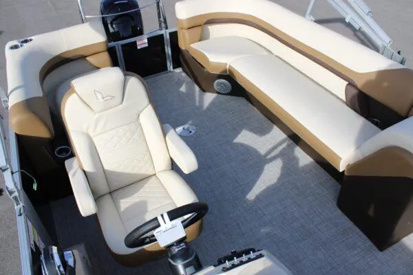 Slide: The Image of 2023 Lowe SF212 boat interior with beige and brown seating and captain's chair. - 8