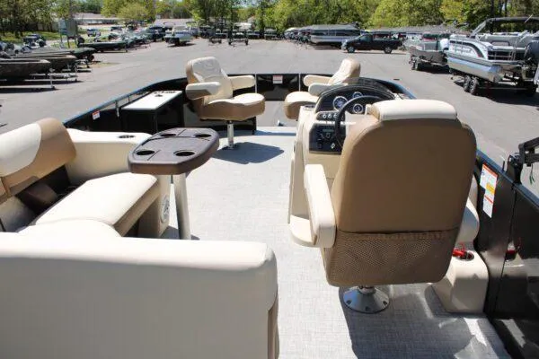 Slide: The Image of 2023 Lowe SF214 Sport Fish pontoon boat interior with beige seating and control console. - 7