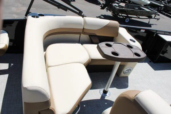 Slide: The Image of 2023 Lowe SF214 Sport Fish boat with beige seating and a table with cup holders. - 9