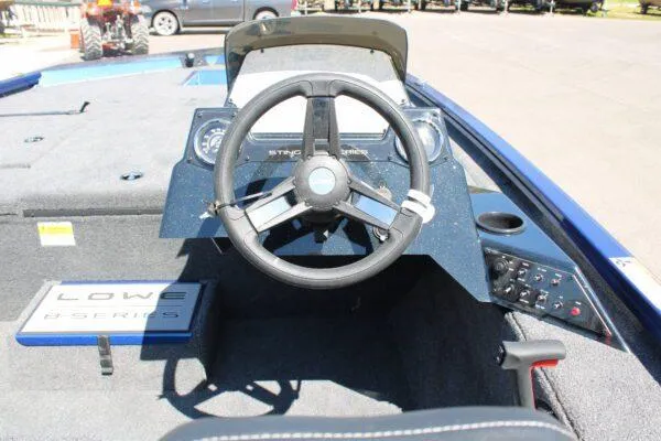 Slide: The Image of 2023 Lowe ST178 boat dashboard with steering wheel and control panel. - 11
