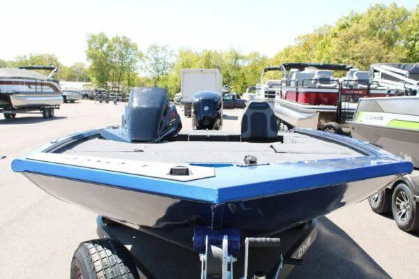 Slide: The Image of 2023 Lowe ST178 boat in a marina, showcasing its sleek design and powerful engine. - 5