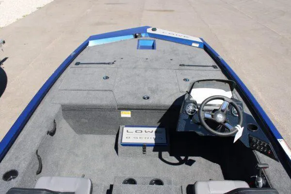 Slide: The Image of 2023 Lowe ST178 boat interior with steering console and seating. - 6