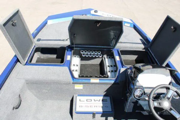 Slide: The Image of 2023 Lowe ST178 boat interior with open storage compartments and steering console. - 8