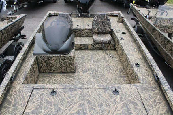 Slide: The Image of 2023 Lowe CAT 20 boat with camouflage design, featuring seating and console. - 4